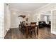 Dining room with hardwood floors, with view to living room, and wall sconces at 1001 Kingsway Dr, Apex, NC 27502