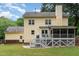 Exterior back of yellow two-story house with deck, screen porch, green lawn, and chimney at 1001 Kingsway Dr, Apex, NC 27502