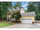 Charming yellow two-story home with black shutters, dormers, and manicured lawn at 1001 Kingsway Dr, Apex, NC 27502