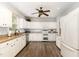 Well-lit kitchen featuring white cabinets, granite countertops, stainless steel appliances, and wood flooring at 1001 Kingsway Dr, Apex, NC 27502
