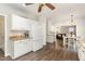 Open kitchen layout with white cabinets, granite countertops, and wood flooring, leading to the living and dining areas at 1001 Kingsway Dr, Apex, NC 27502