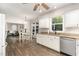 Bright kitchen with white cabinets, granite countertops, stainless steel appliances, and a view to the dining and living areas at 1001 Kingsway Dr, Apex, NC 27502