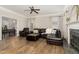 Elegant living room with dark brown sectional, fire place, and hardwood floors at 1001 Kingsway Dr, Apex, NC 27502