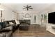 Elegant living room with dark brown sectional, fire place, and hardwood floors at 1001 Kingsway Dr, Apex, NC 27502