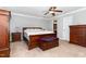 Comfortable main bedroom with a king bed, wooden furniture, and views of the ensuite bathroom at 1001 Kingsway Dr, Apex, NC 27502