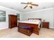Spacious main bedroom with a king bed, wooden furniture, carpet flooring, and plenty of natural light at 1001 Kingsway Dr, Apex, NC 27502
