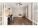 Spacious office with hardwood floors, large windows, built in shelves and a work desk at 1001 Kingsway Dr, Apex, NC 27502