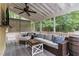 Relaxing screened porch with comfortable seating, ceiling fan, and views of the private backyard at 1001 Kingsway Dr, Apex, NC 27502