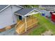 Beautiful new back porch featuring wooden railings and staircase with lattice at 1006 S Second Ave Ave, Siler City, NC 27344