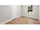 A simple bedroom featuring hardwood floors and natural lighting at 1006 S Second Ave Ave, Siler City, NC 27344