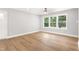 A bedroom with natural light has wood floors, and a ceiling fan at 1006 S Second Ave Ave, Siler City, NC 27344