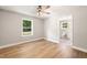 Bright bedroom features a ceiling fan, light gray walls, wood-look flooring, and an ensuite bathroom at 1006 S Second Ave Ave, Siler City, NC 27344