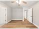 An empty bedroom with ceiling fan, hardwood floors, and neutral colored walls at 1006 S Second Ave Ave, Siler City, NC 27344