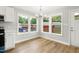 A dining area is lit by a modern chandelier with windows, and it has wood flooring at 1006 S Second Ave Ave, Siler City, NC 27344