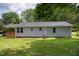 The backyard is surrounded by lush greenery and wood porch at 1006 S Second Ave Ave, Siler City, NC 27344