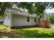 Back view of home with a well-manicured lawn, and wood porch at 1006 S Second Ave Ave, Siler City, NC 27344