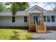 Charming home featuring a new blue front door and wood porch at 1006 S Second Ave Ave, Siler City, NC 27344