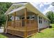 The covered front porch is surrounded by landscaped yard at 1006 S Second Ave Ave, Siler City, NC 27344