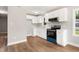 Bright kitchen with white cabinets, modern appliances, and light wood flooring at 1006 S Second Ave Ave, Siler City, NC 27344