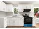 A bright kitchen featuring white cabinets and stainless steel appliances at 1006 S Second Ave Ave, Siler City, NC 27344
