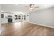 Open-concept living room with white cabinets, wood flooring, and natural light at 1006 S Second Ave Ave, Siler City, NC 27344
