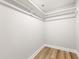 A bright walk-in closet featuring hardwood floors and white shelving at 1006 S Second Ave Ave, Siler City, NC 27344