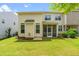 Spacious backyard with manicured lawn, screened-in porch, and mature trees providing privacy and shade at 1007 Epiphany Rd, Morrisville, NC 27560