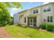 Well-maintained backyard featuring a screened-in porch, lush lawn, and mature landscaping for outdoor enjoyment at 1007 Epiphany Rd, Morrisville, NC 27560