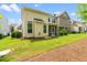 Beautifully landscaped backyard with lush green lawn, screened porch, and mature trees providing shade and privacy at 1007 Epiphany Rd, Morrisville, NC 27560