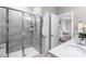 Bright bathroom with tiled shower and glass door adjacent to an opening to the main bedroom at 1007 Epiphany Rd, Morrisville, NC 27560