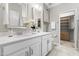 Bright bathroom featuring double vanity, a large mirror and access to closet at 1007 Epiphany Rd, Morrisville, NC 27560