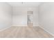 An empty carpeted bedroom featuring neutral walls and a view to the hallway and other rooms at 1007 Epiphany Rd, Morrisville, NC 27560