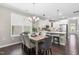 Charming dining area with modern light fixture adjacent to the open kitchen with stainless steel appliances at 1007 Epiphany Rd, Morrisville, NC 27560