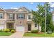 Charming townhouse featuring a brick and siding facade, one-car garage and well-manicured landscaping at 1007 Epiphany Rd, Morrisville, NC 27560