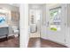 Hallway view showing laundry room and half bathroom with stylish finishes and hardwood flooring at 1007 Epiphany Rd, Morrisville, NC 27560