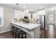 Kitchen featuring quartz countertops, stainless steel appliances, and stylish barstool seating at 1007 Epiphany Rd, Morrisville, NC 27560