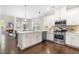 Modern kitchen with stainless steel appliances, quartz countertops, and hardwood flooring at 1007 Epiphany Rd, Morrisville, NC 27560