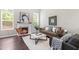 Spacious living room with a fireplace, large windows, and stylish decor at 1007 Epiphany Rd, Morrisville, NC 27560