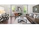 Inviting living room with a fireplace, large windows, and comfortable seating at 1007 Epiphany Rd, Morrisville, NC 27560