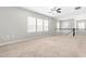 Spacious loft area with plush carpeting, ceiling fan, natural light, and railing overlooking lower level at 1007 Epiphany Rd, Morrisville, NC 27560