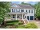 Charming two-story home with a welcoming front porch and beautifully landscaped front yard at 101 Ironcreek Pl, Apex, NC 27539