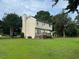 Spacious backyard with mature trees and a well-kept lawn, plus a wooden deck and walk-out basement at 101 New Castle Ct, Youngsville, NC 27596