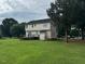 Green backyard with mature trees, featuring a deck, walk-out basement, and plenty of space for outdoor enjoyment at 101 New Castle Ct, Youngsville, NC 27596