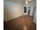 Bedroom with wooden floors and natural light streaming through a window at 101 New Castle Ct, Youngsville, NC 27596