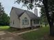 Traditional home with a chimney, vinyl siding, and a well-maintained lawn, offering comfort and charm at 101 New Castle Ct, Youngsville, NC 27596