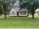 Quaint single-story home with symmetrical design, mature trees, and lush lawn for a serene curb appeal at 101 New Castle Ct, Youngsville, NC 27596