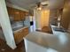 Traditional kitchen with wooden cabinets, white appliances, and an eat-in bar at 101 New Castle Ct, Youngsville, NC 27596