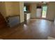 Open-concept living area with a ceiling fan, wood floors, and natural light, perfect for gatherings and daily living at 101 New Castle Ct, Youngsville, NC 27596