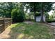 Large backyard with mature trees, wood fence, and fire pit at 101 Stefi Ct, Garner, NC 27529
