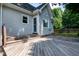 Charming backyard features a spacious wooden deck, light grey siding, and mature trees at 101 Stefi Ct, Garner, NC 27529